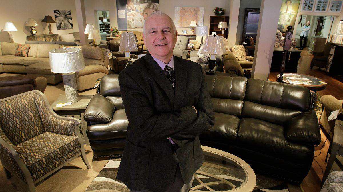 Lynnwood Mueller, newly retired president of Mueller Furniture in Belleville, stands in a showroom at the 26,000 square-foot Belleville store in this 2017 file photo.