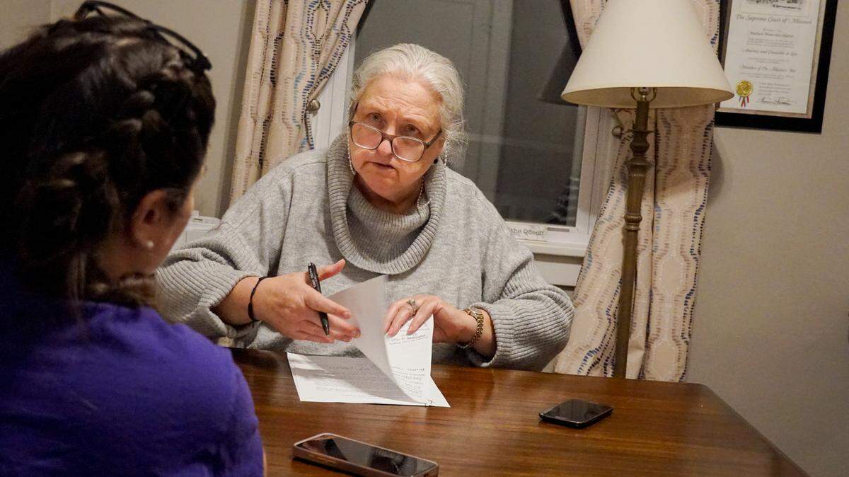 Marleen Menendez Suarez works with an undocumented client on guardianship paperwork at her office on Monday, Jan. 27, 2025, in Fairmont City, Ill.
