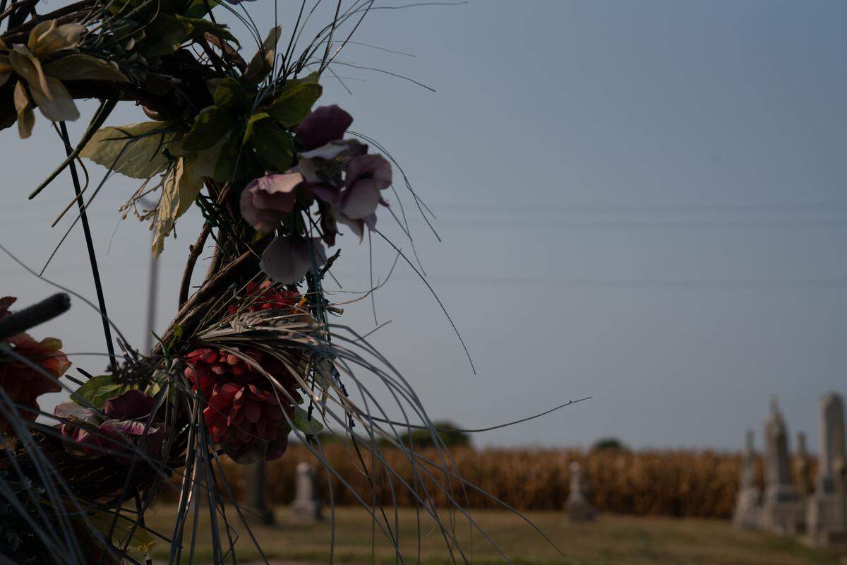 Each labor day, hundreds descend upon the Union Miners Cemetery to drop off relics of their loved ones, such as this wreathe. In the background lie other graves and a large cornfield that showcases Mount Olive’s historic and contemporary working class nature.