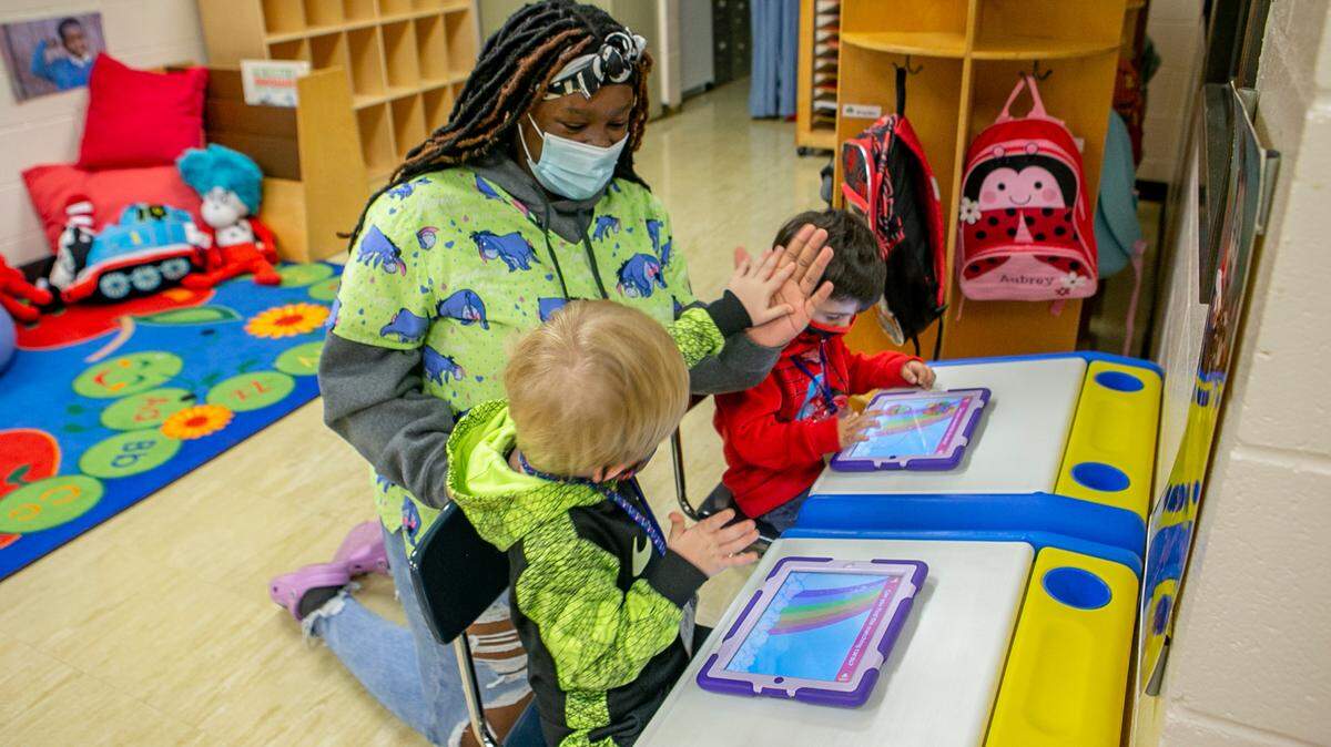In this file photo, a Collinsville High School student works with a pre-kindergarten student at the early childhood daycare operated through the Collinsville Area Vocational Center.