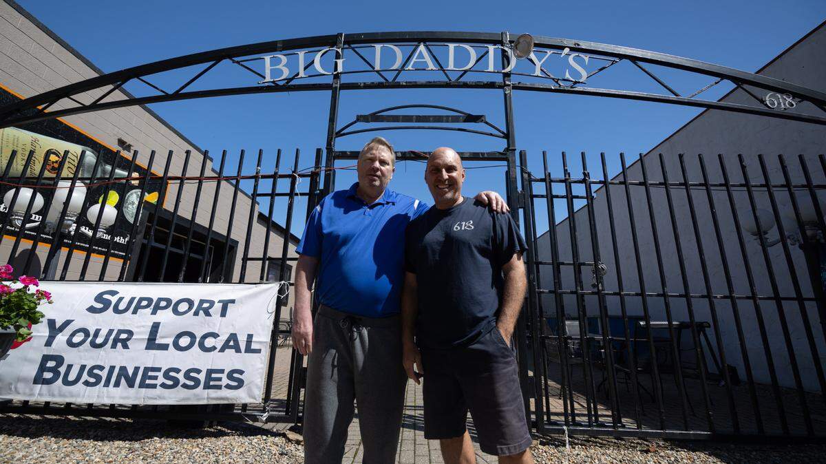 Scott Schmelzel and James “Jimbo” Sinovic, co-owners of Big Daddy’s 618 in Belleville, stand in front of their bar on East Main Street.