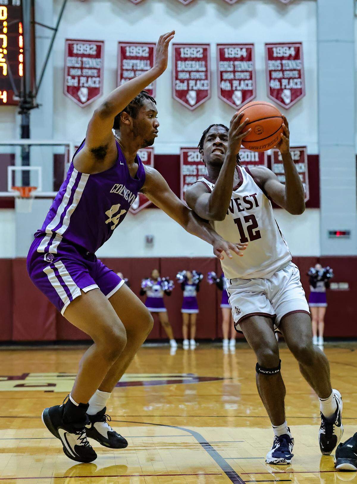Belleville West’s Myles Liddell drives to the basket against Collinsville’s Zach Chambers during Friday night’s Southwestern Conference game. The Kahoks ultimately posted a 71-60 victory.