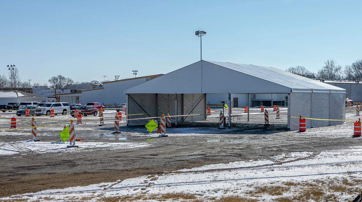 People check in under a large tent before getting shots at a mass COVID-19 vaccination clinic at Belle-Clair Fairgrounds in Belleville. This photo was taken last week, when St. Clair County agencies were preparing for the clinic’s opening on Monday.