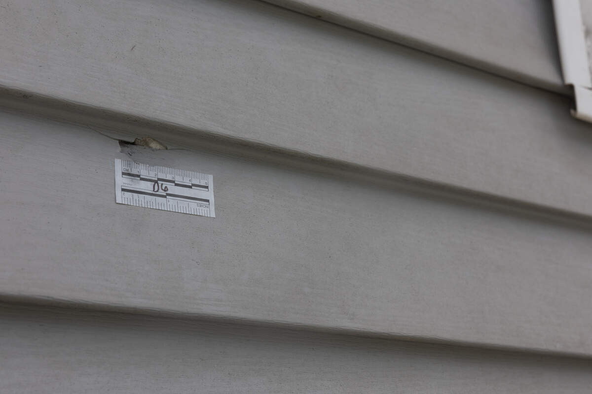 A bullet hole with an evidence marker is still in place at a home that was the scene of a drive-by shooting along the corner of Selb St. and Market St. in Venice.