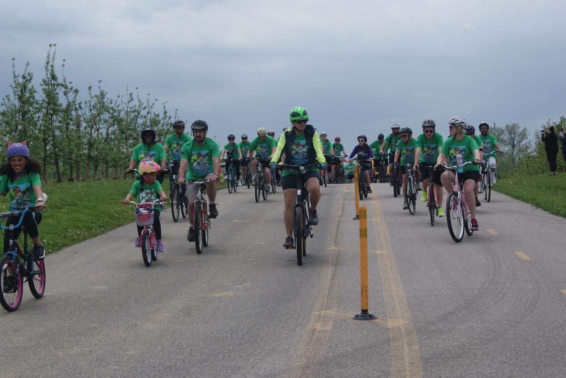 Bike riders cruise through an orchard at Eckert’s near the start of the Tour de Belleville on Saturday. The annual bike ride raises money for the Belleville Parks and Recreation Department.