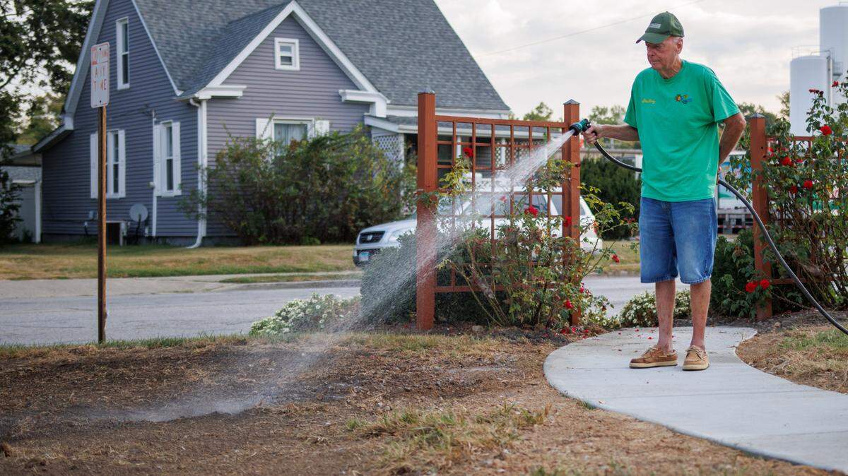 Sterling Garnto, 77, waters the grass at O’Fallon Garden Club in O’Fallon, IL on Friday, September 20, 2024.