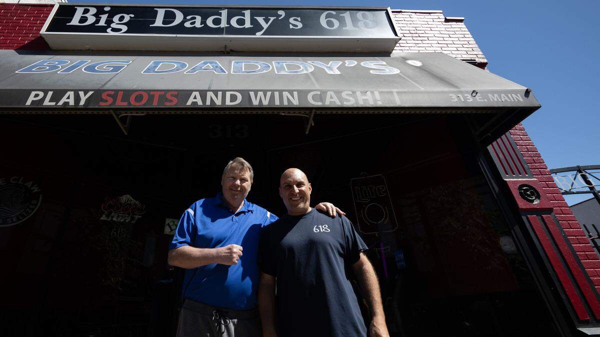 James “Jimbo” Sinovic, left, and Scott Schmelzel, co-owners of Big Daddy’s 618 in Belleville, stand in front of their bar on East Main Street. They’re planning to close next March after 20 years.