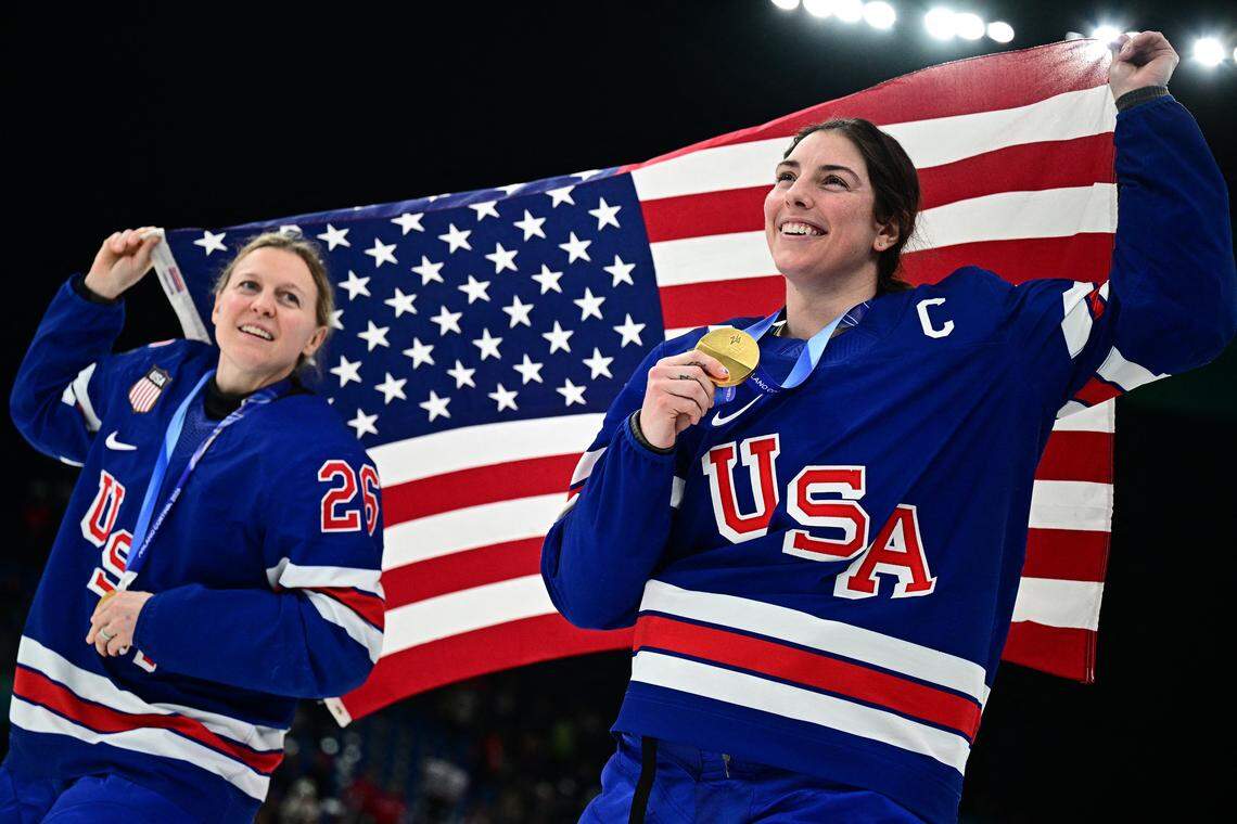 USA's #26 Kendall Coyne (L) and USA's #21 Hilary Knight celebrate during the medals ceremony for the women's ice hockey event at the Milano Santagiulia Ice Hockey Arena during the Milano Cortina 2026 Winter Olympic Games in Milan, on February 19, 2026. (Photo by JULIEN DE ROSA / AFP via Getty Images)