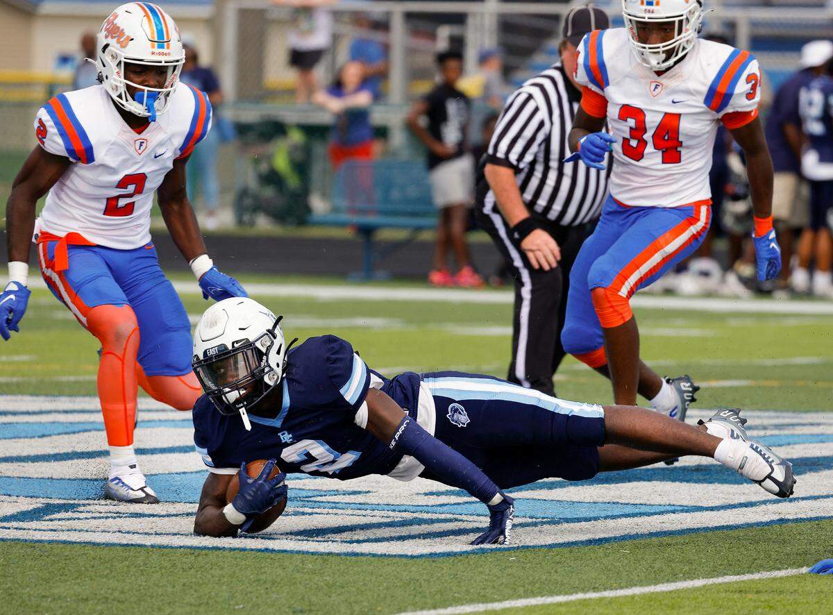 Belleville East’s Markevious Curition dives forward against visiting East St. Louis during a Southwestern Conference game Saturday. The Flyers coasted to a 57-0 victory.