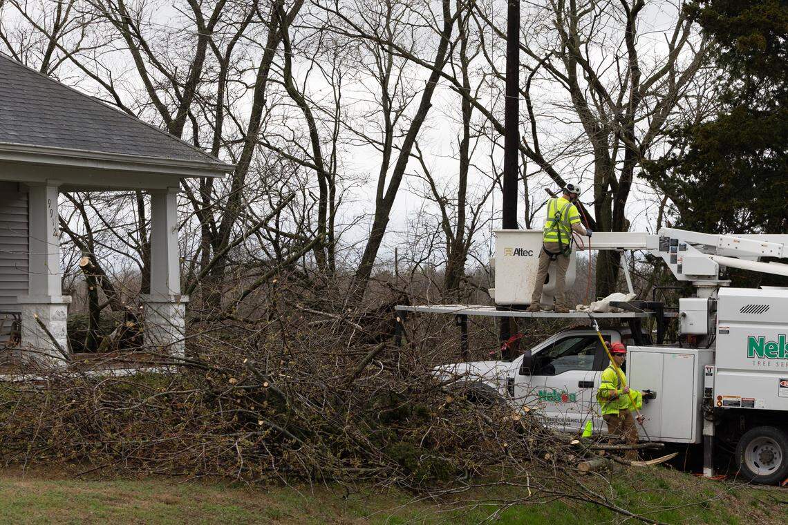 Contractors for a tree service help remove a fallen branches from a Lenzburg home after heavy storms passed through the area.