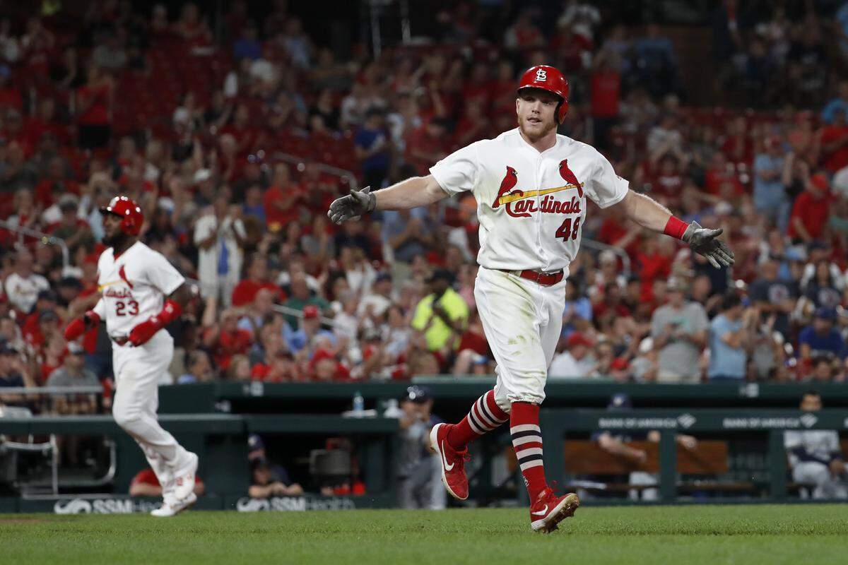 St. Louis Cardinals’ Harrison Bader celebrates after drawing a bases loaded walk from Milwaukee Brewers relief pitcher Junior Guerra to as Cardinals’ Marcell Ozuna, left, comes in to tie the game during the sixth inning of a baseball game Tuesday, Aug. 20, 2019, in St. Louis. (AP Photo/Jeff Roberson)