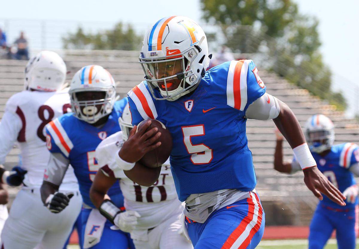 Tyler Macon picks up yardage during East St. Louis’ win over Belleville West for the top spot in the Southwestern Conference.