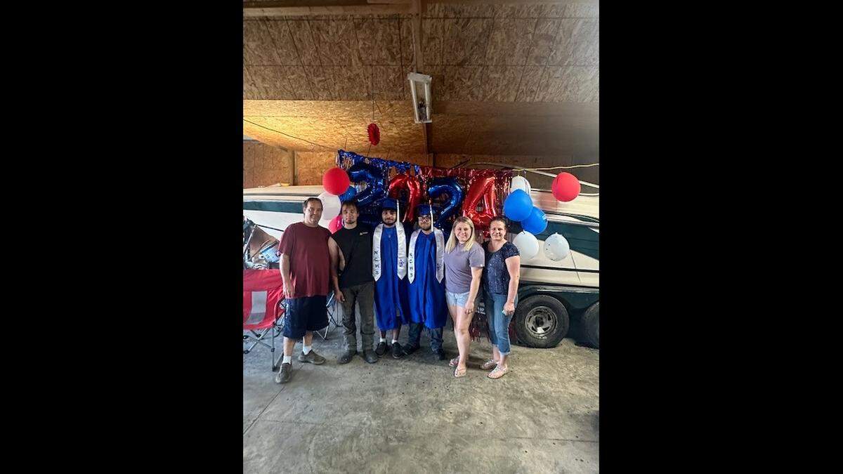 John Davis (left) with family. John was impaled by a pole during a mid-November accident and is now on the road to recovery.