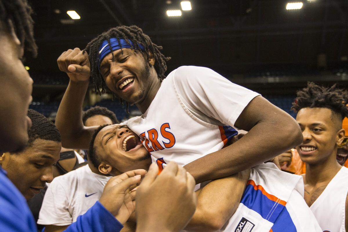 March 12, 2019 - Springfield, IL - East St.LouisÕ Elijah Rice and East St.LouisÕ Terrence Hargrove Jr. celebrate the flyerÕs victory over Springfield (Southeast) at the IHSA 3A Super-Sectional basketball game Tuesday night in Springfield. Photo: Chris Johns