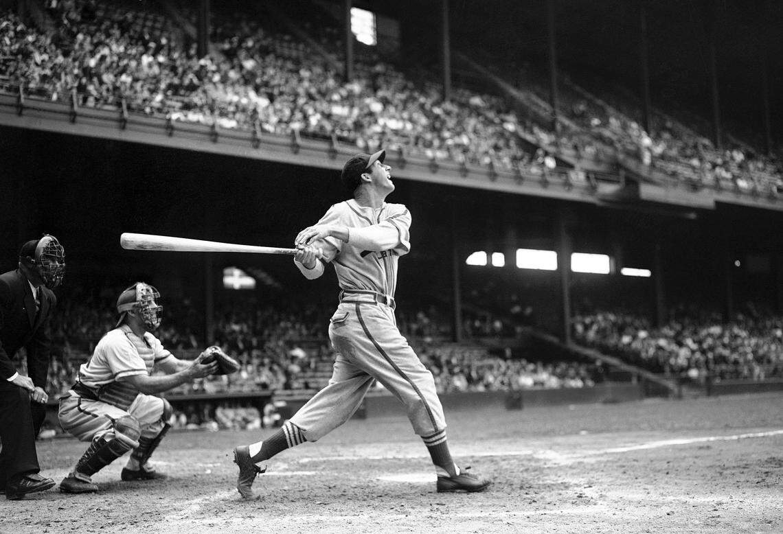 Stan Musial bats against the Philadelphia Phillies during a baseball game at Shibe Park in Philadelphia, 1946. (AP Photo/Warren M. Winterbottom, File)