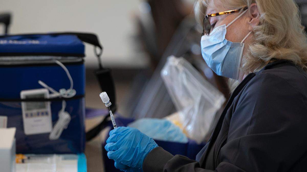 A healthcare worker prepares a dose of the COVID-19 vaccine at a clinic hosted by The East Side Health District. They have been holding vaccine clinics at the Clyde C. Jordan Senior Citizens Center in East St. Louis as well as other locations.