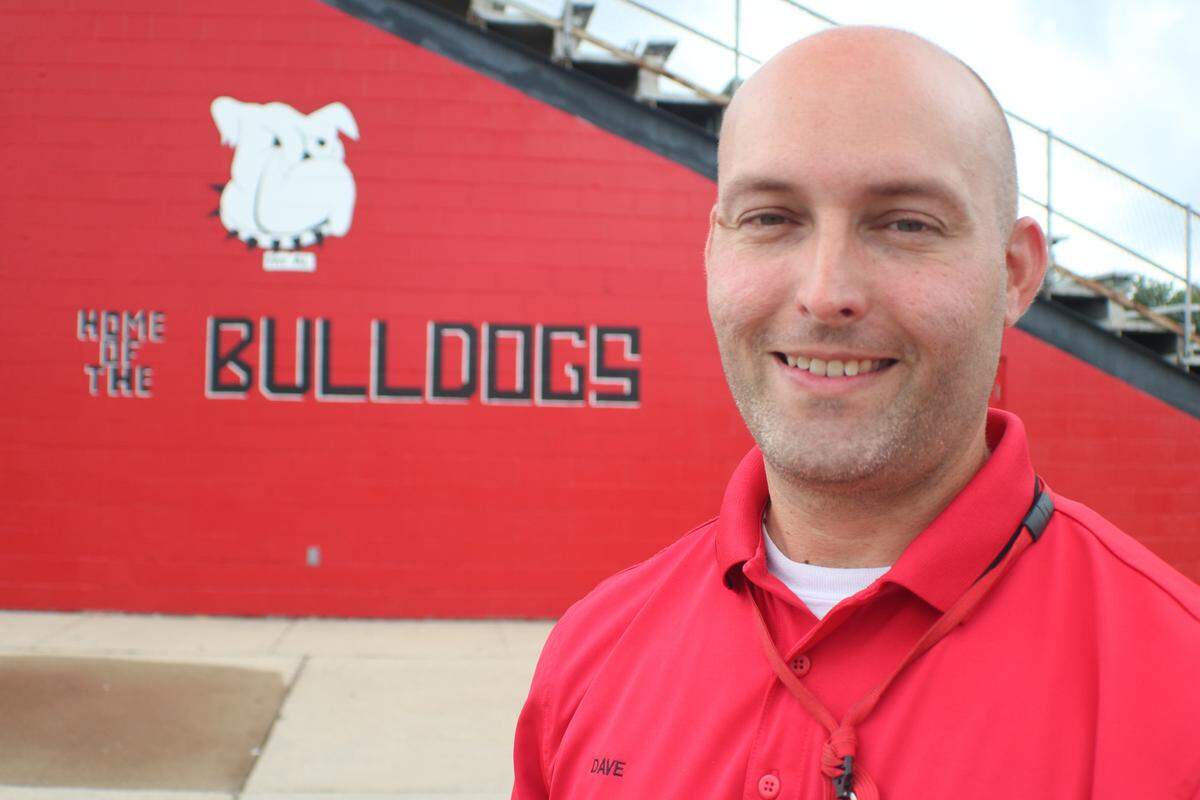 Highland School District custodian Dave Bourgeois stands in front of the new mural at the Highland High School football stadium. The artwork is a recreation of the original mural painted on the stadium sometime in the 1970s. A round of power-washing recently exposed the mural. Bourgeois was the artist to restore the painting.
