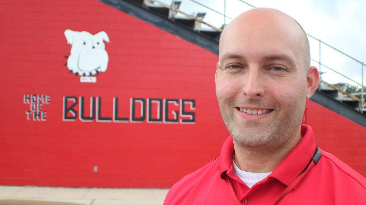 Highland School District custodian Dave Bourgeois stands in front of the new mural at the Highland High School football stadium. The artwork is a recreation of the original mural painted on the stadium sometime in the 1970s. A round of power-washing recently exposed the mural. Bourgeois was the artist to restore the painting.