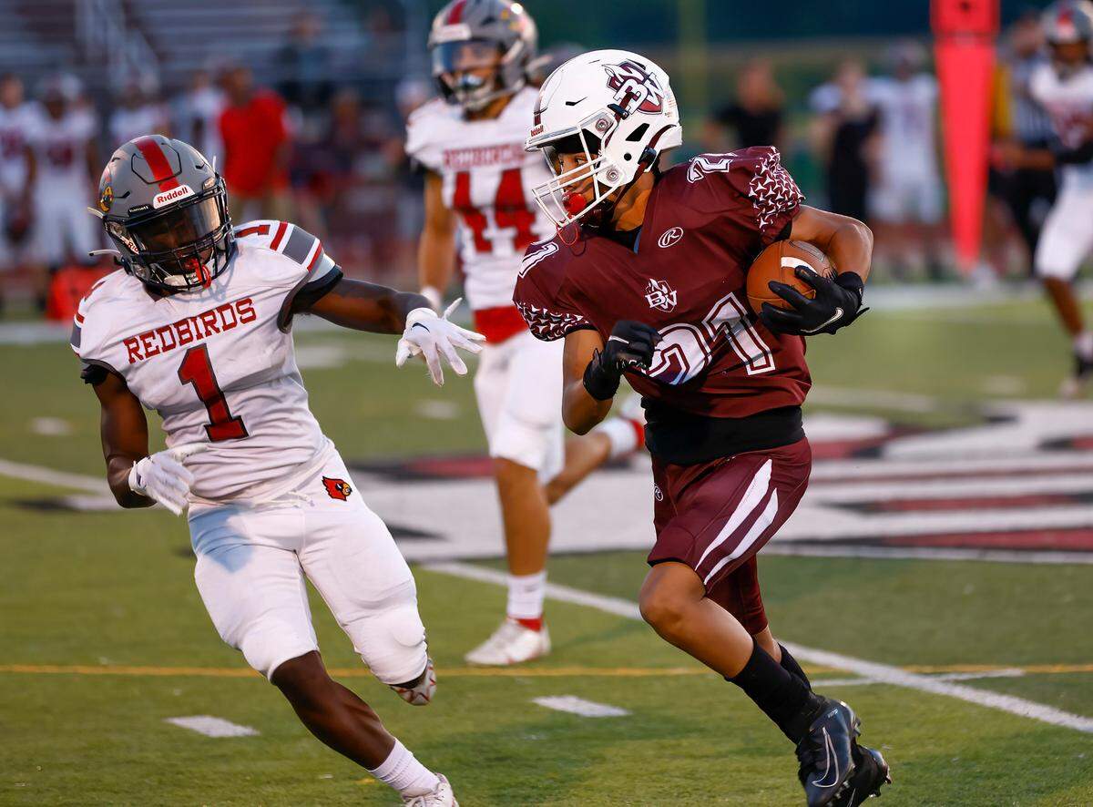 Belleville West’s Exavier Zeilman runs the ball against Alton in a Southwestern Conference game Sept. 16. The Redbirds ultimately prevailed 28-7.
