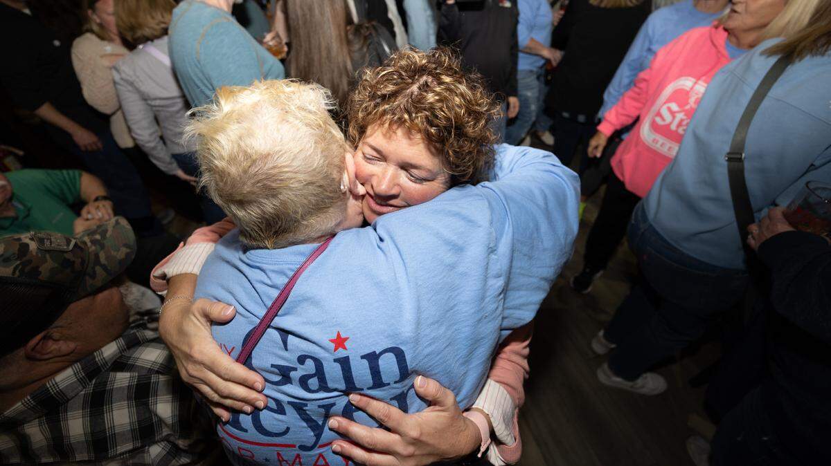 Belleville City Clerk Jenny Gain Meyer hugs her mother, Rosemary Hamann, on Tuesday night after learning that she had been elected mayor. Supporters were gathered at Tavern on Main restaurant and bar.