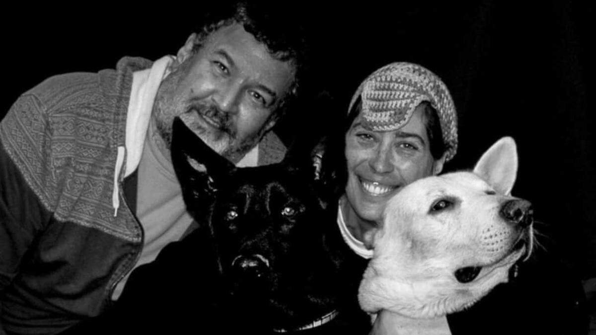Gene Triefenbach and his wife, Chrissy Meggs, of New Athens, are shown with their German shepherds, Samson and Leviathan, before Meggs was diagnosed with lung cancer six years ago.