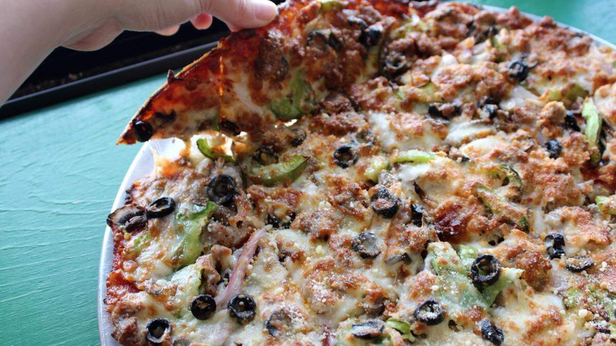 Here’s how pizza chains and local spots like Papa Vito’s, seen here, compared on pricing.