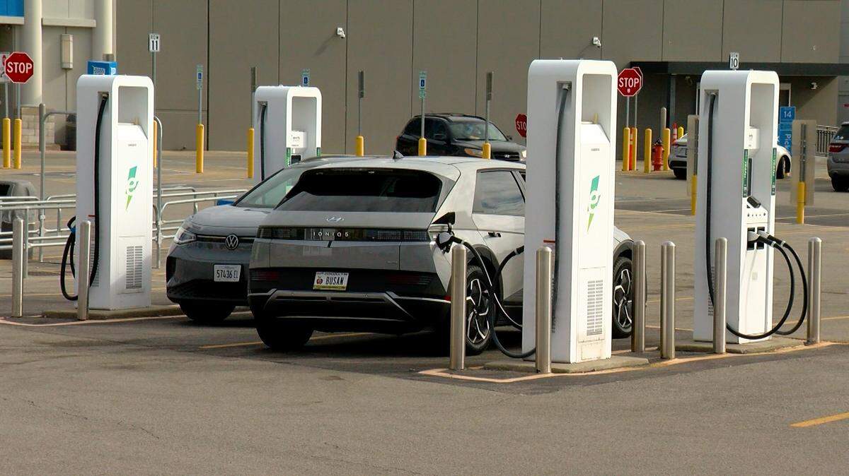 Two electric vehicles are pictured at a charging station in Springfield. 