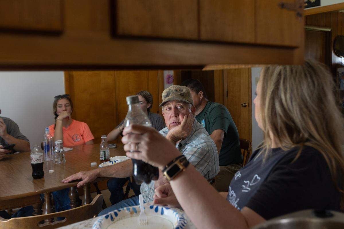 Williams takes a lunch break with his family at his mother’s house on the farm in June.