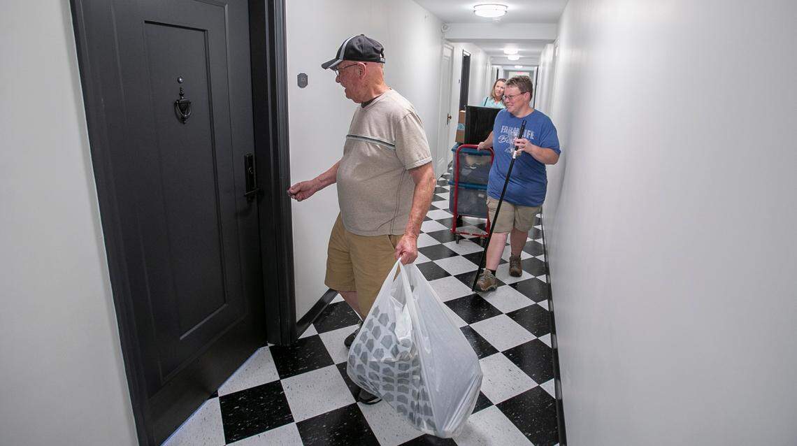 Robert Butcher unlocks the door of his new efficiency apartment at Lofts on the Square at 16 S. Illinois St. in Belleville. He has moving help from his daughters, Shonda Butcher and Rhonda Grove. 