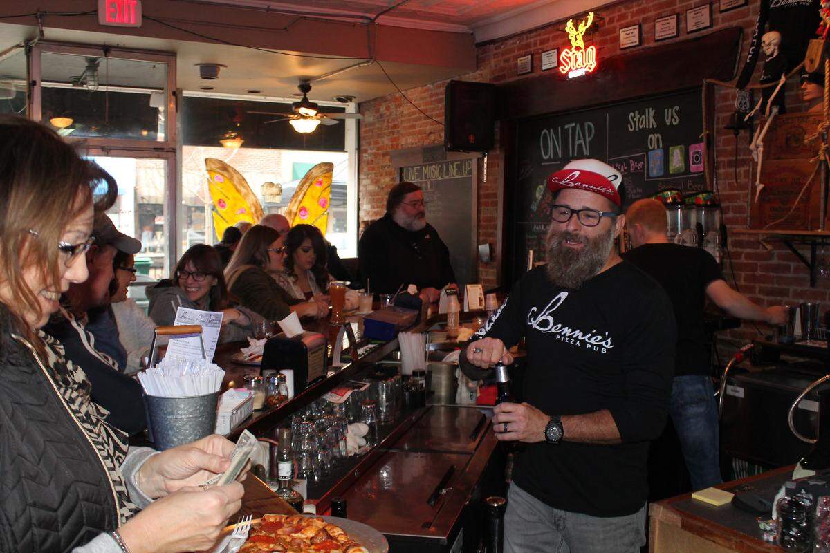 Bennie Parr Jr., right, said he enjoyed seeing customers at has businees, Bennie’s Pizza Pub on Main Street in downtown Belleville, during the Small Business Saturday event.