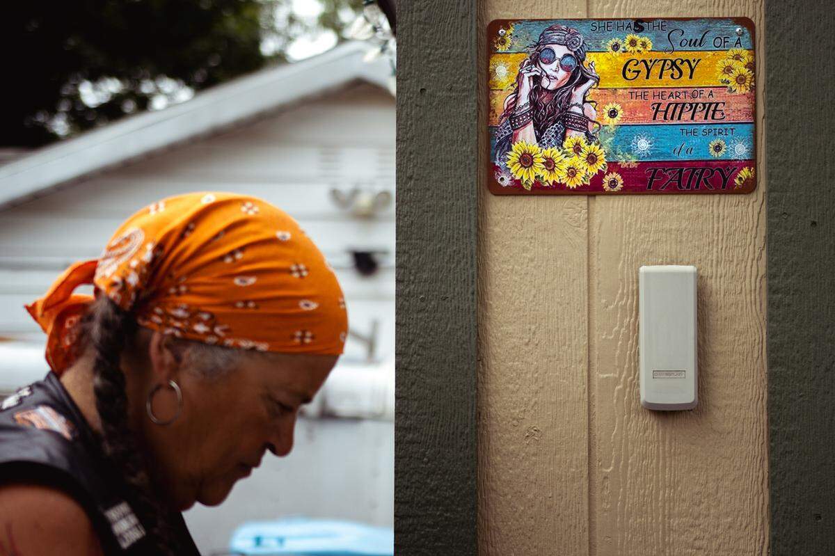 Decor is affixed to Tina Weber’s garage on Sunday, July 21, 2024, at her home in Collinsville, Illinois. “I just felt connected to it,” she said of a free-spirited lifestyle. “I always considered myself to be a Gypsy in the wind.”