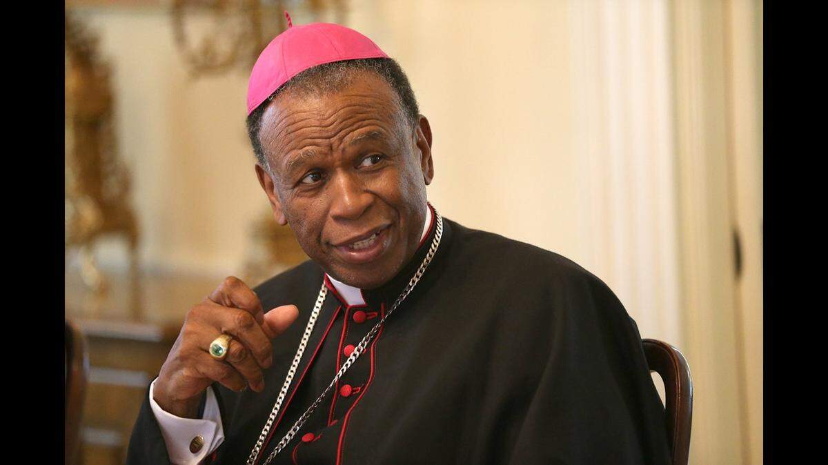 Bishop Edward K. Braxton of the Catholic Diocese of Belleville listens to a comment from a guest during a luncheon at his residence in 2015.