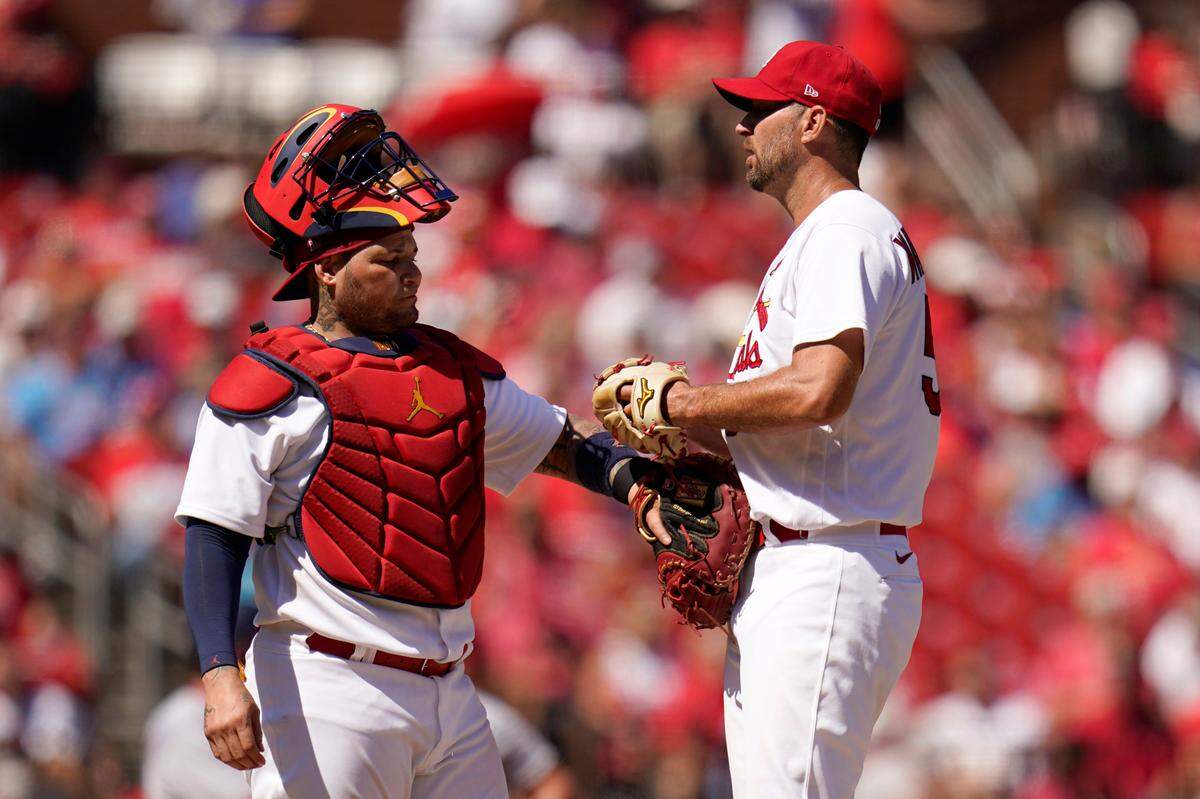 Former St. Louis Cardinals catcher Yadier Molina, left, talks to starting pitcher Adam Wainwright during a game against the Washington Nationals last season. In Jeff Jones’ latest column, Wainwright is one area of focus in a good-natured survey that includes several team members.