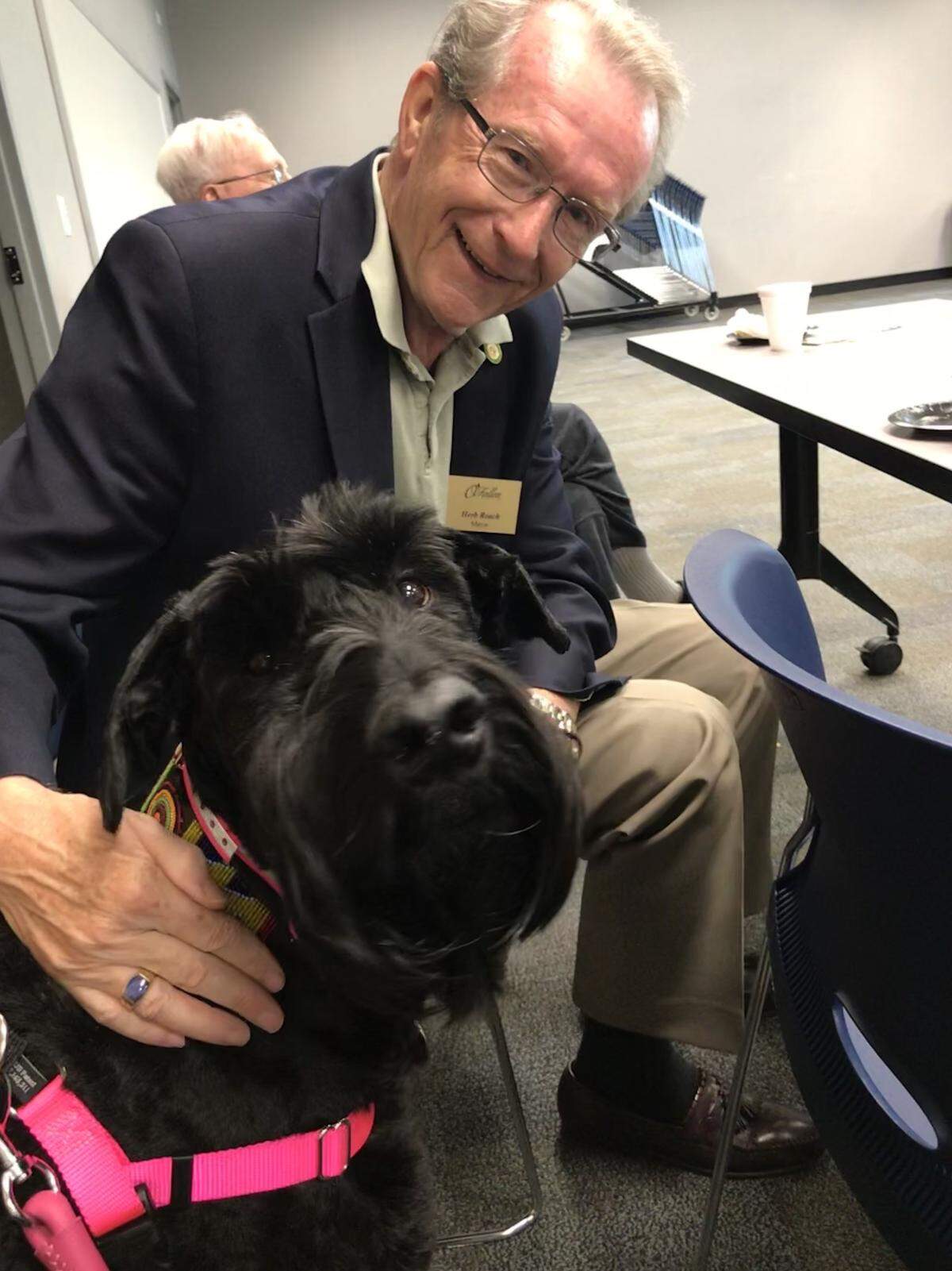 O’Fallon Mayor Herb Roach is pictured with Sophie, Julie Hughes’ dog who passed away this year. Hughes, the owner of Furchild, a specialty pet boutique in O’Fallon, is the event coordinator for this Saturday’s Downtown Dog Days event.