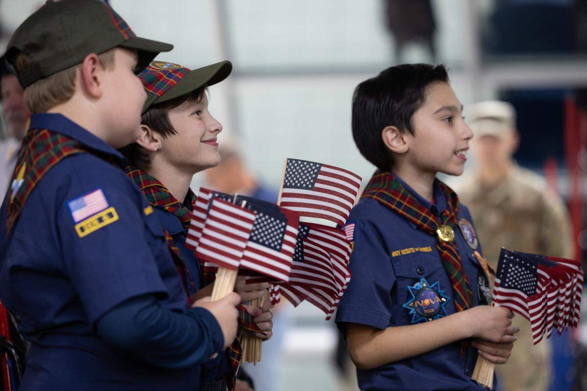 Members of the St. Louis Boy Scouts wait to greet veterans as they arrive from the Greater St. Louis Honor Flight.