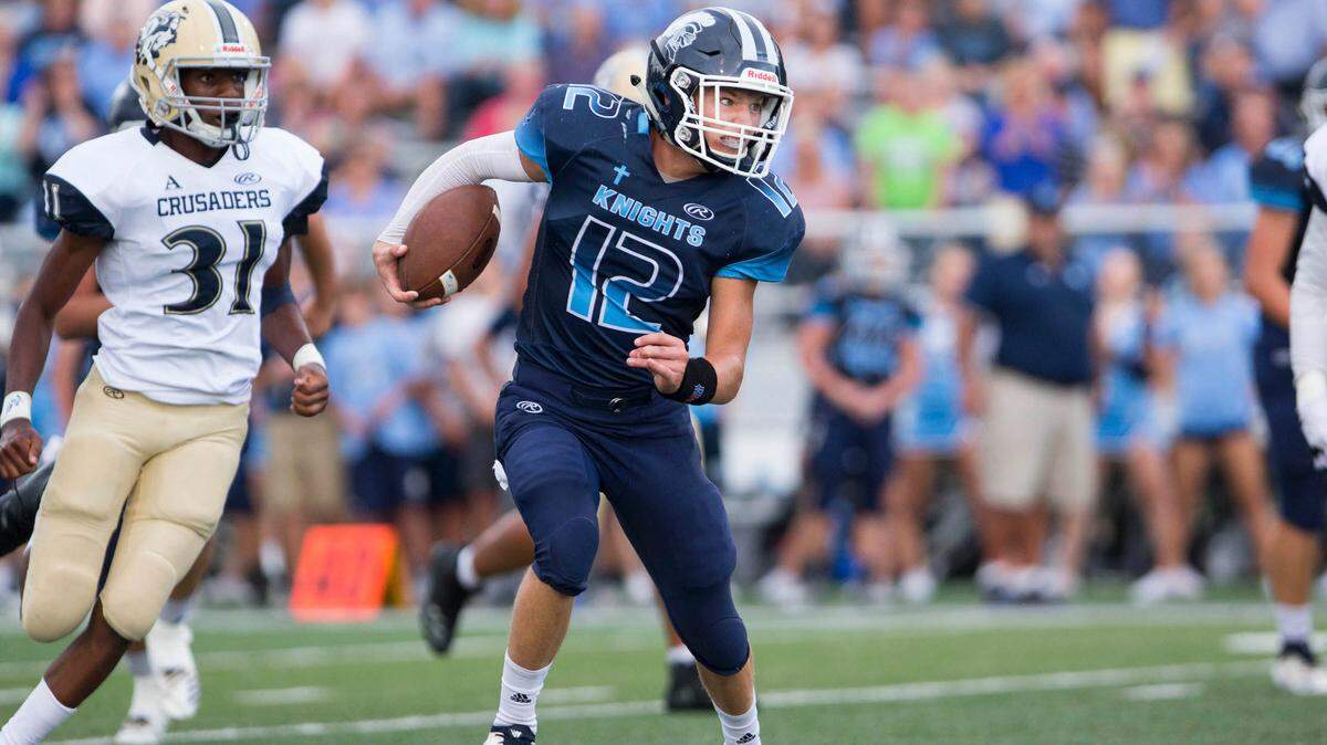 Mater Dei’s Travis Jasper carries the ball against Althoff Friday night in Breese.