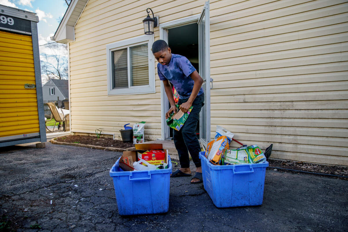 Malachi, 12, takes out the recycling during a break from schoolwork at his Bolingbrook home in April. Police wrote the middle school student a ticket for battery last fall after he got in a fight. “I didn’t know at my age stuff could happen like that for doing what I did at school,” he said.