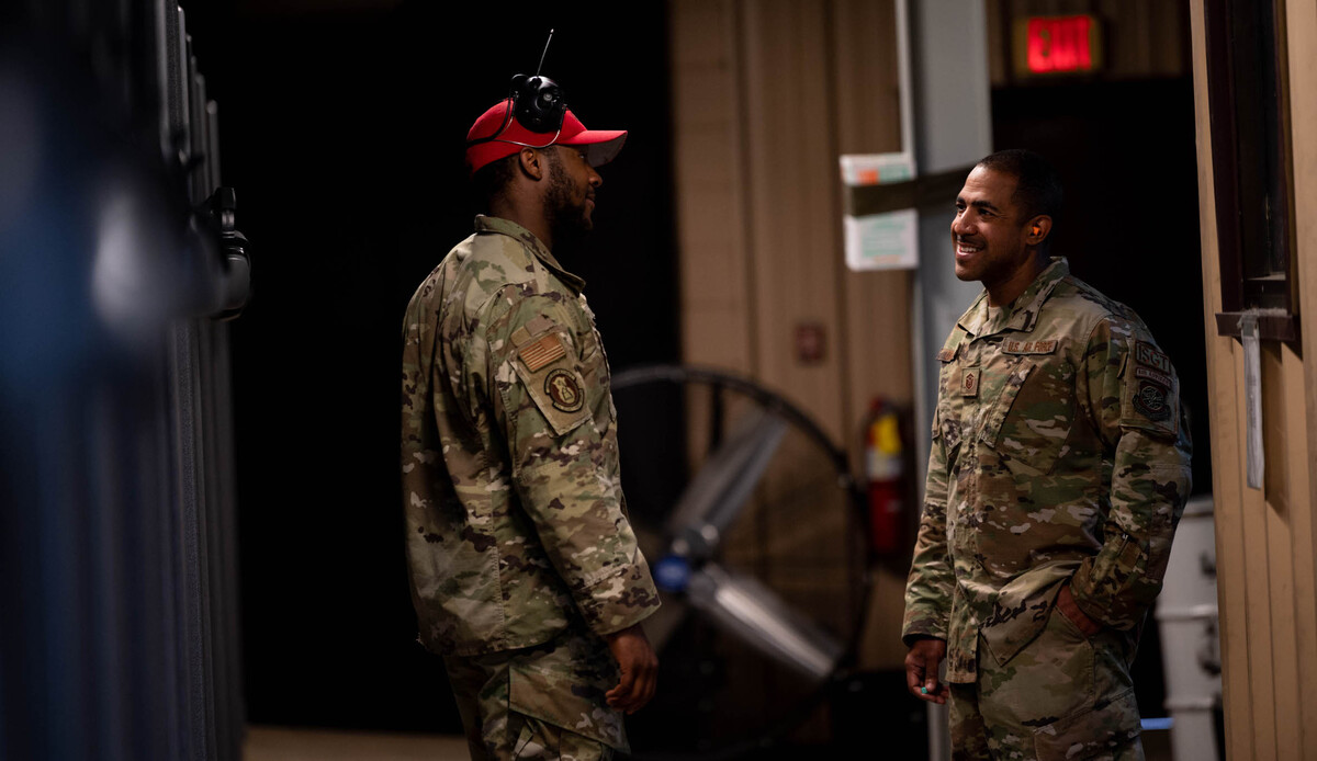 From left, U.S. Air Force Senior Airman Jaonte Horden, 375th Security Forces Squadron combat arms instructor, and Master Sgt. John Ortiz, 375th Security Forces first sergeant, share a laugh in the Combat Arms Training and Maintenance shooting range on Scott Air Force Base. This light-hearted moment was prior to a shooting competition between members of Team Scott and first responders from the local community during National Police Week.