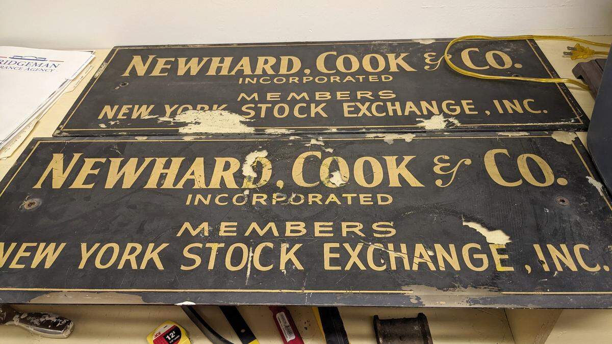 Robert Eckman and Steve Mathews, the new owners of the old Belleville Savings Bank building in downtown Belleville, found old signs for Newhard, Cook & Co. when they started clearing out an old office. The brokerage firm operated at 20 E. Main St. from 1963 to 1992.