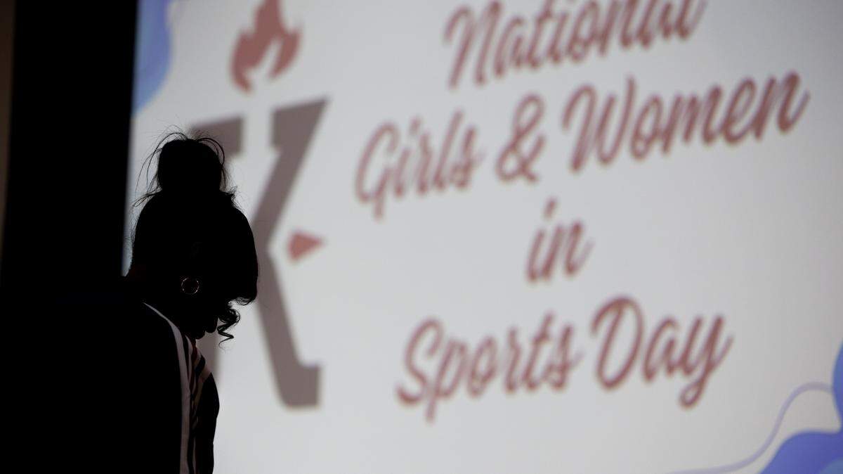 Jackie Joyner-Kersee stands in front of a display during an event for Women and Girls in Sports Day at the Jackie Joyner-Keree Foundation.
