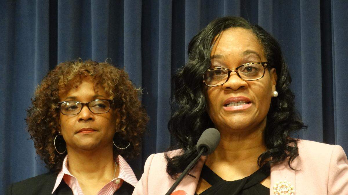 Senate Majority Leader Kimberly Lightford (front) and Rep. Camille Lily speak at a news conference Tuesday about their legislation to reform the state’s Medicaid managed care system.
