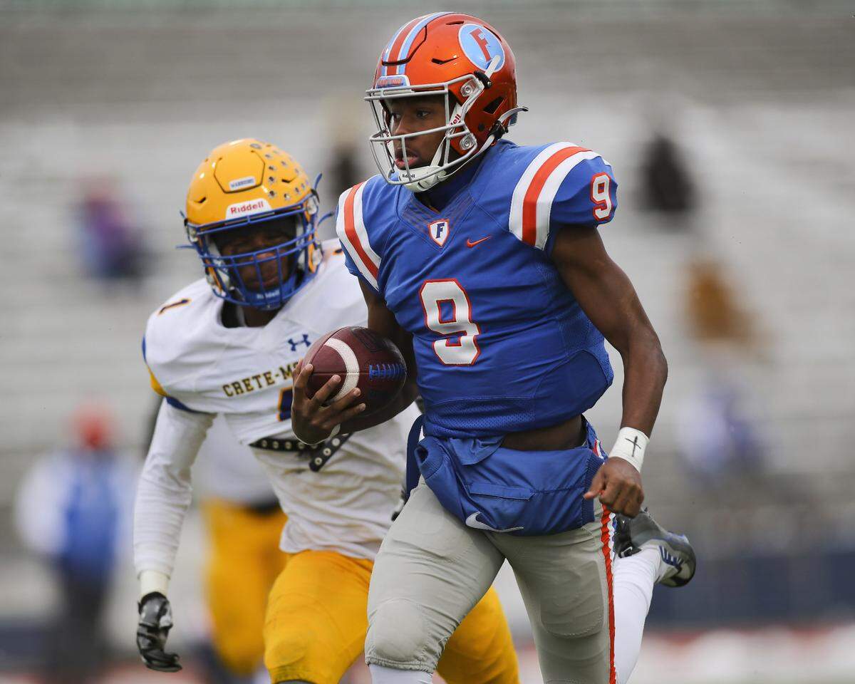 November 12, 2022 - East St. Louis, IL - East St. Louis quarterback Robert Battle carries the ball for a touchdown on the first play from scrimmage during the IHSA, 6A, Quarterfinal playoff game between Crete - Monee and East St. Louis. The 45-0 victory will advance the Flyers to the Semifinals. [Photo: Chris Johns]