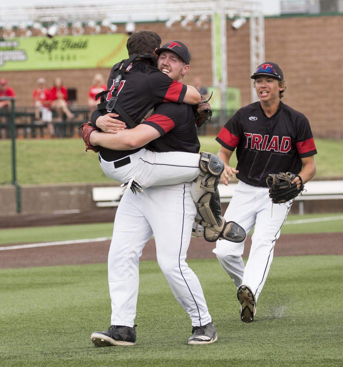 Triad's Nick Beeler and Matt Weis celebrate after clinching the Class 3A super-sectional Monday at GCS Stadium in Sauget.
