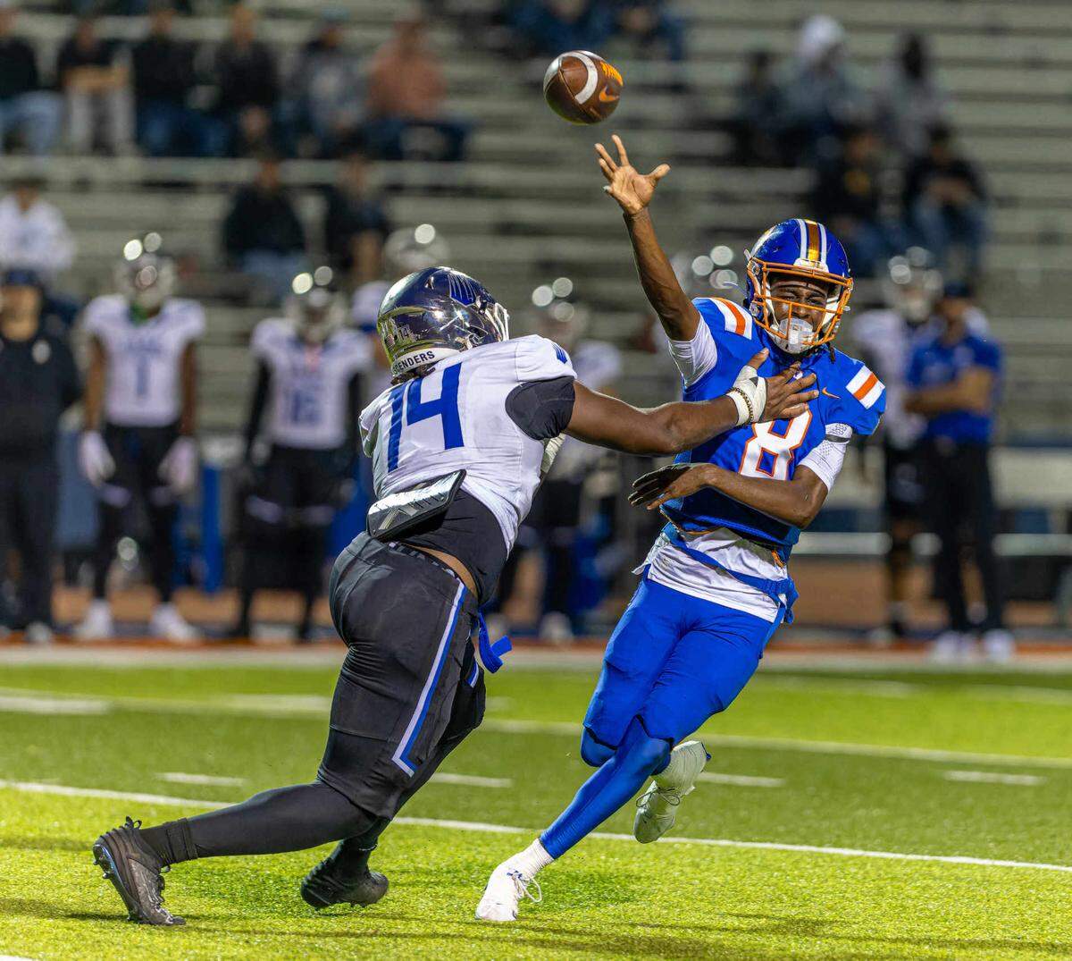 East St. Louis quarterback Kendrick Lyons (8) throws the ball while under pressure from the IMG Academy rush at Clyde Jordan Stadium Friday.