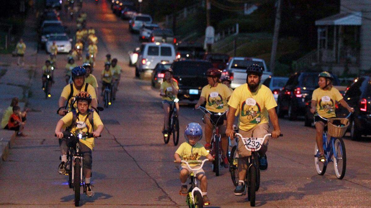 Tour de Belleville bicyclists have included people of all ages and backgrounds and bikes of all shapes and sizes. Here, a family with young children is shown participating in the 2014 ride.