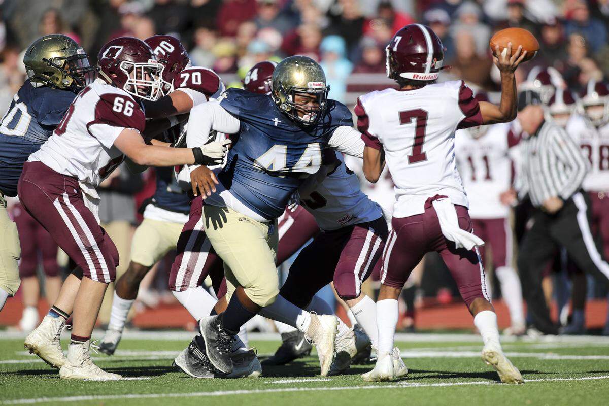 Althoff’s Christopher Jenkins puts pressure on Red Bud quarterback Dylan Oliver during an IHSA Class 2A second round playoff game against Red Bud. The Crusaders prevailed 26-14 and now advance to the quarterfinal round.