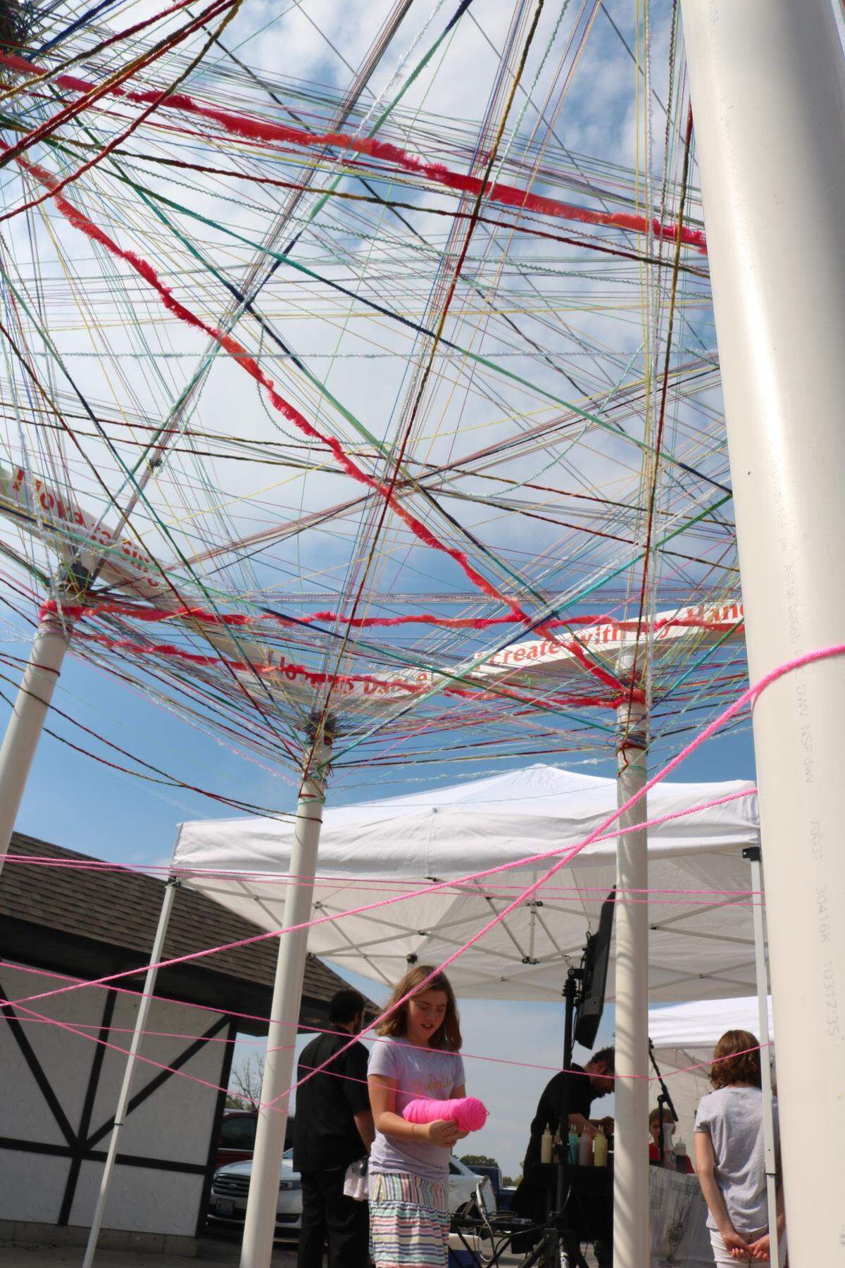 Jossilyn Gaffner wraps yarn around a unity project at last year’s Art in the Park event. The annual two-day, outdoor, juried exhibit and sale of works will be held at Oct. 13 and 14 at Lindendale Park in Highland. The event is free to the public and will encompass many different forms of artwork from over 70 professional artists. The event is hosted by the Highland Arts Council.