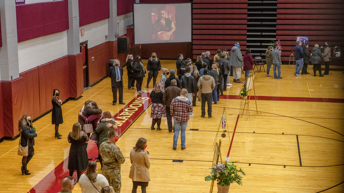 Friends, family and students of Belleville West High School teacher Bob Flake attend a visitation held inside the school gymnasium on Saturday. Flake, who died on Dec. 30, was the head of the school’s science department and he had previously served as offensive coordinator for the football team. He was 40.