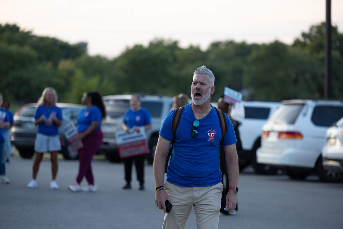Ray Roskos, the Illinois Federation of Teachers field service director who assists Cahokia Federation of Teachers Local 1272, leads chants advocating for fair contracts outside a September Cahokia school board meeting.