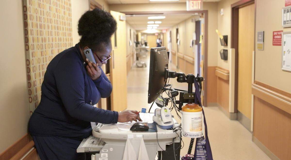 A Memorial Hospital nurse works at her portable workstation on one of the patient floors in the Belleville Hospital.